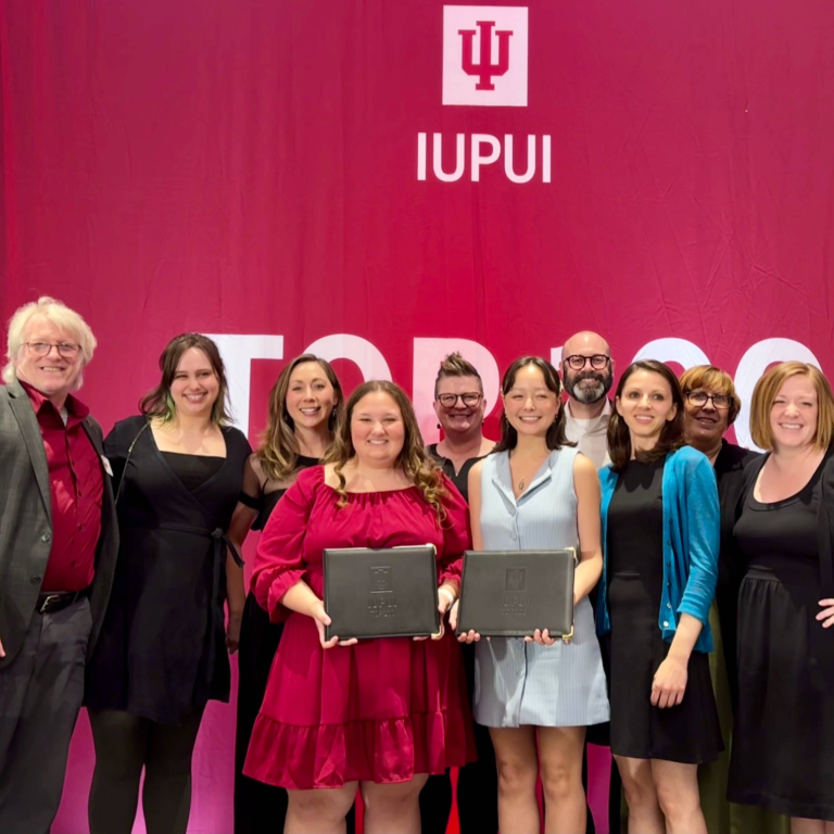 Group shot of Herron School of Art and Design faculty and staff surrounding Michaela Di Palmo and Ginger Miller, recipients of IUPUI's Top 100 award