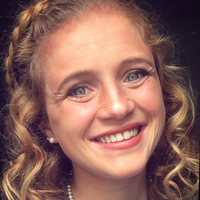 Extreme close-up of Kaitlyn Pulos's smiling face.